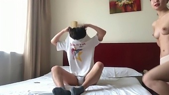 A Pair Of Chinese Lovers Share Intimate Moments In A Hotel Suite
