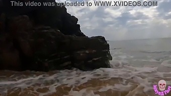 A Steamy Encounter Between A Pair At A Beach In View Of Others
